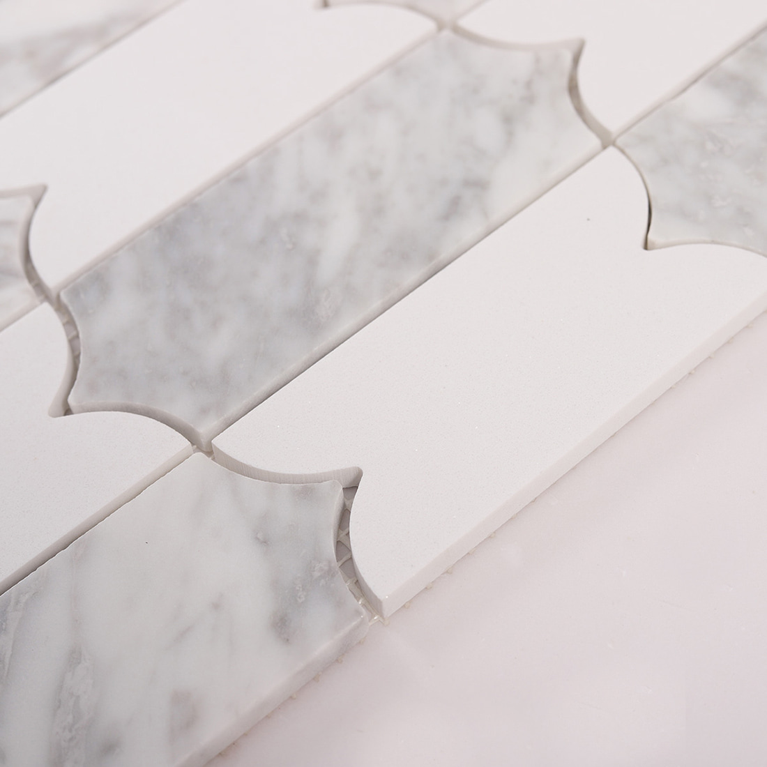 Close up of lantern shaped marble mosaic tiles showing texture and joints