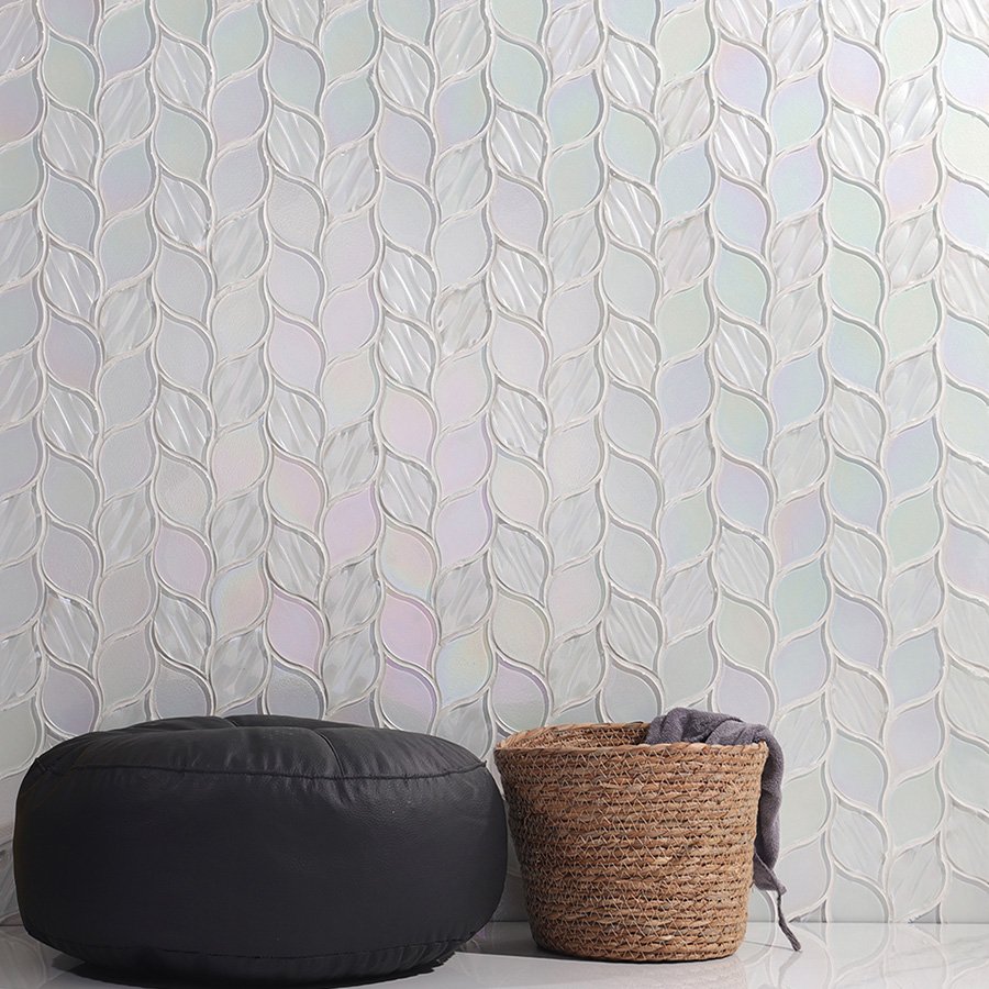 Decorative wall covered with white glass iridescent leaf mosaic tiles in modern interior.