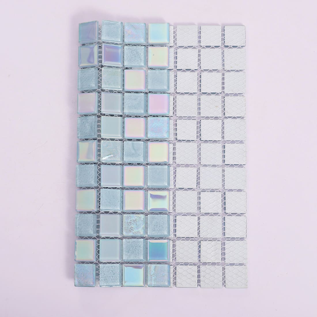 Light blue iridescent square glass mosaic tile showing mesh backing