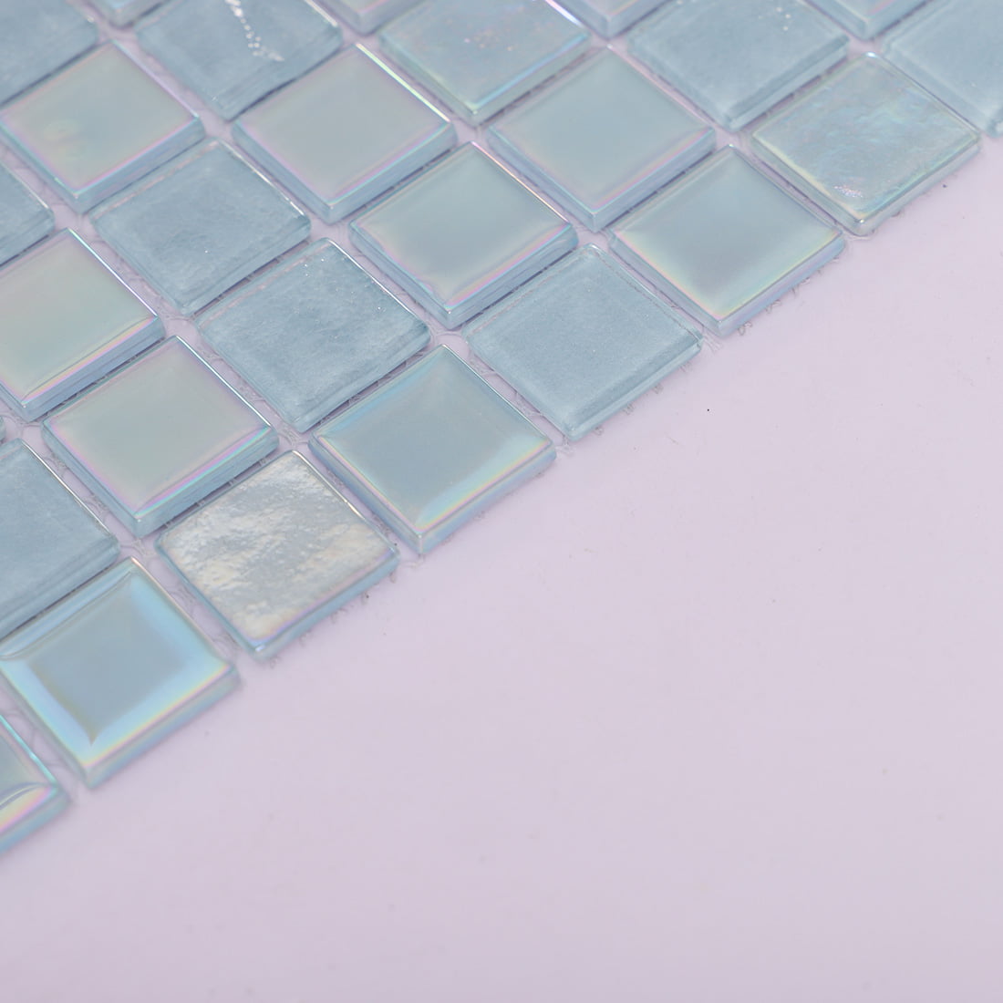 Angled detail of light blue square glass mosaic tiles 