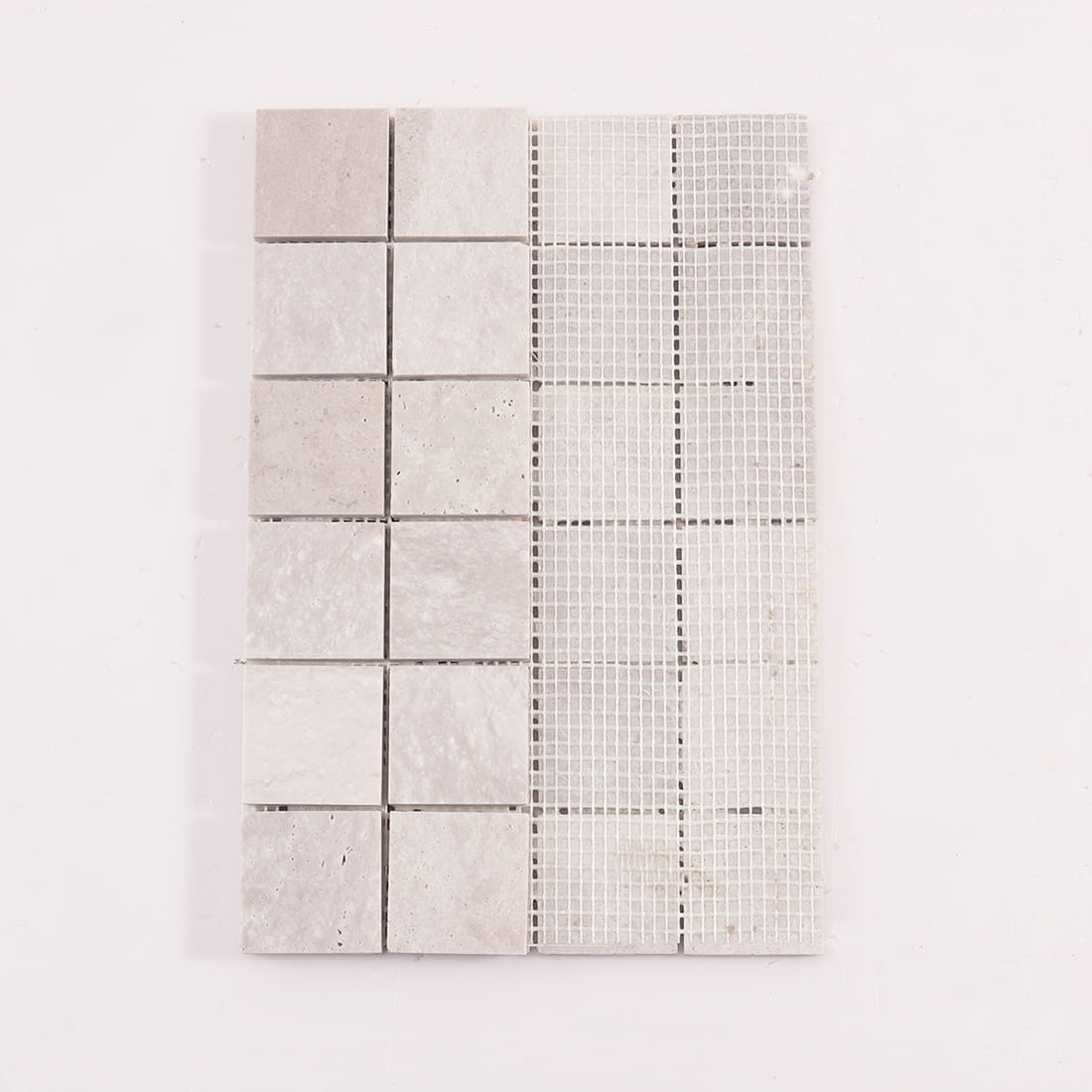 Back view of light gray marble square mosaic tiles mounted on mesh backing