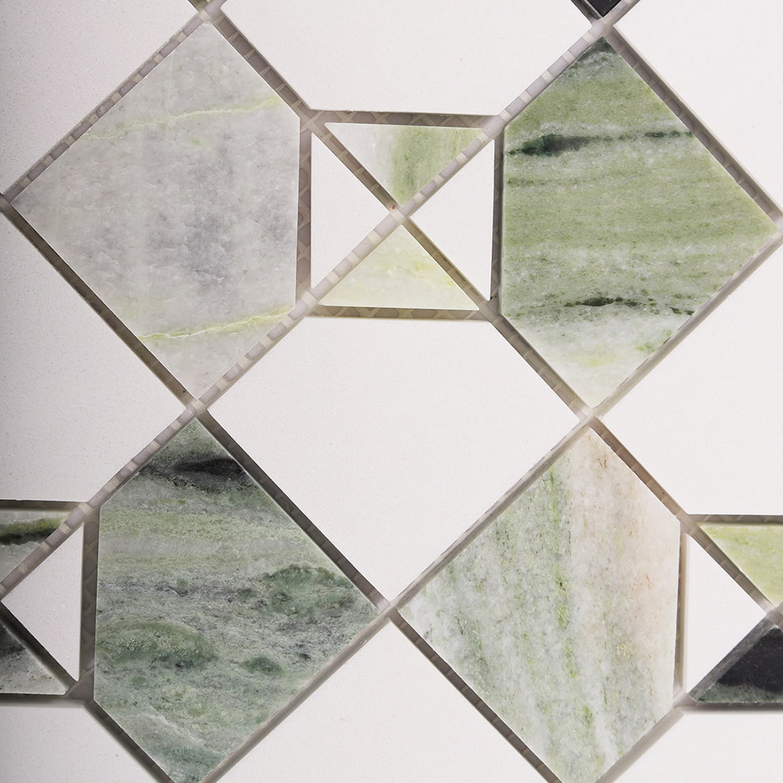 Close up of light green marble and white square mosaic pattern with triangle accents