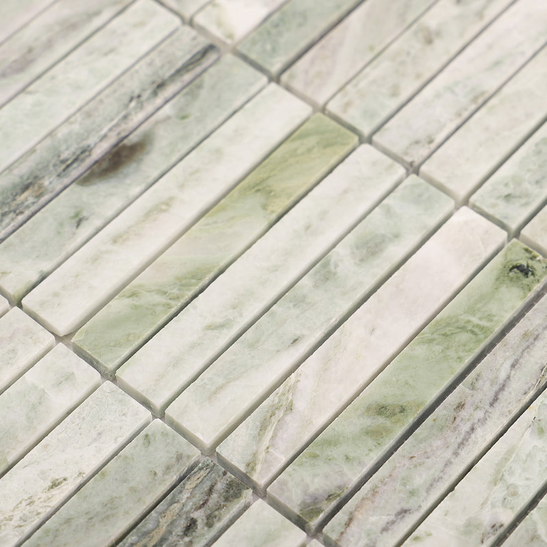 Angled closeup of light green marble mosaic strips showing edges and spacing