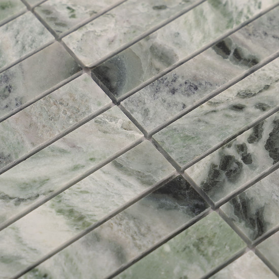 Closeup of light green marble strips highlighting mixed tones and veining detail