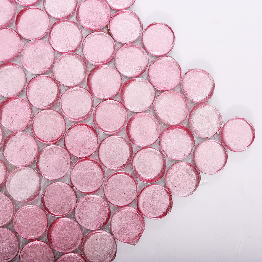 Corner close up of light pink penny round glass mosaic tiles