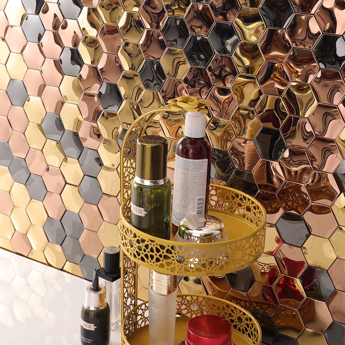 Glamorous mixed metal hexagon wall tiles paired with gold bathroom accessories.