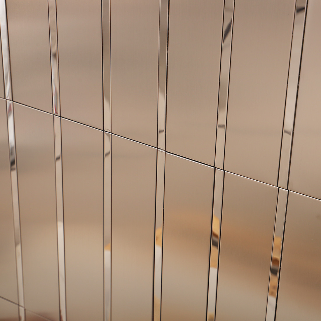 Macro shot of silver brushed metal mosaic tile surface with polished strips