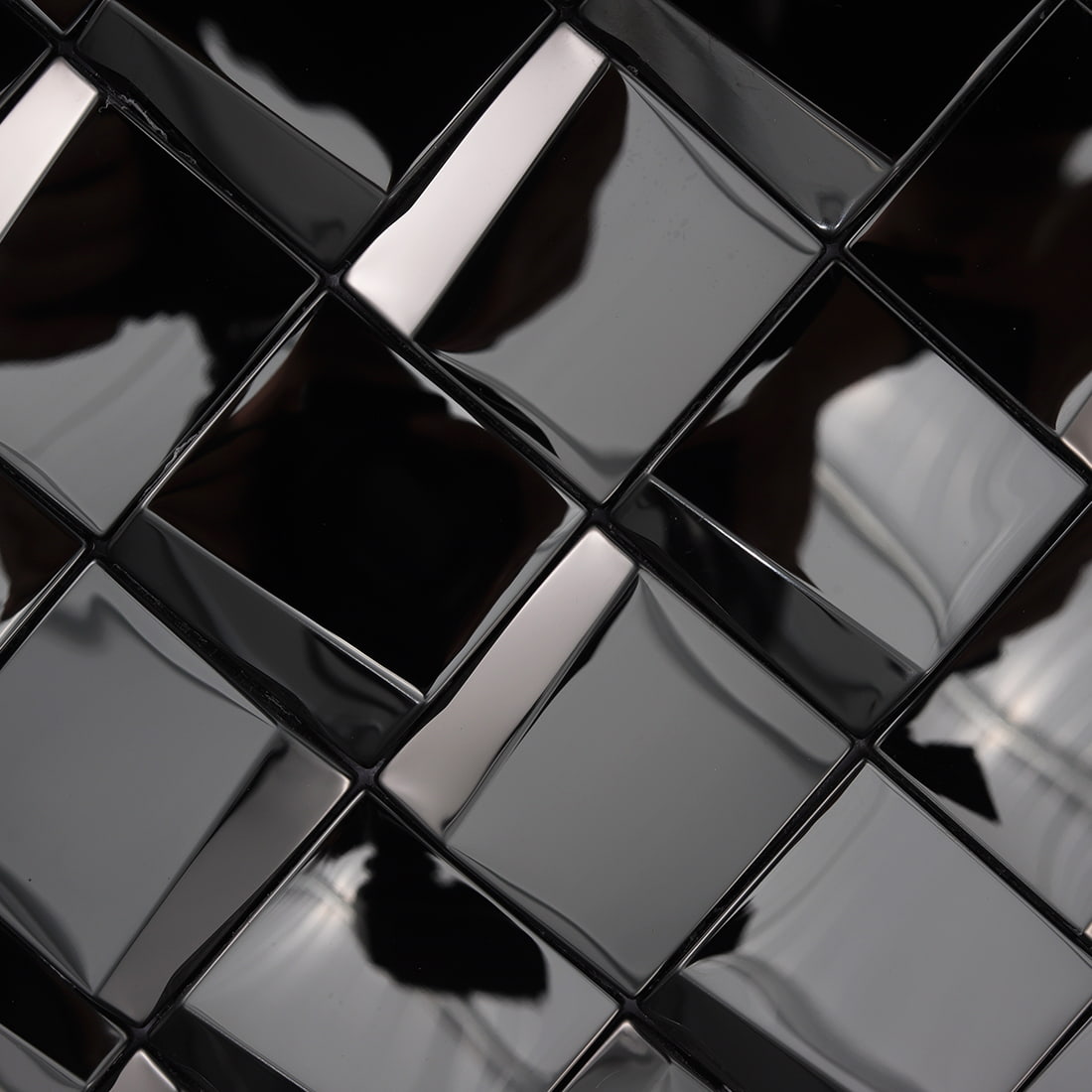 Macro view of the reflective black 3D geometric mosaic tile surface.