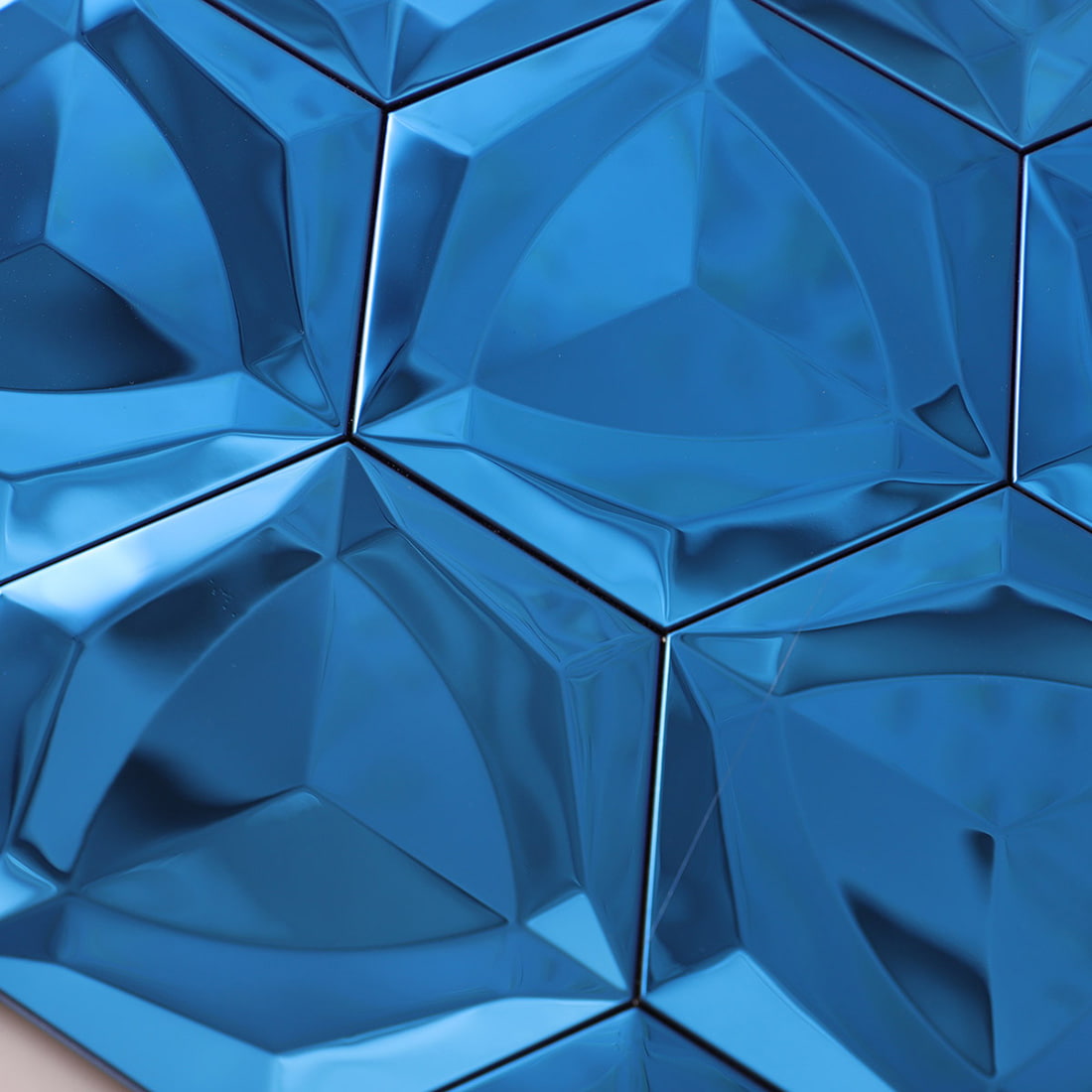 Macro view of a blue 3D hexagon tile highlighting the diamond facets.