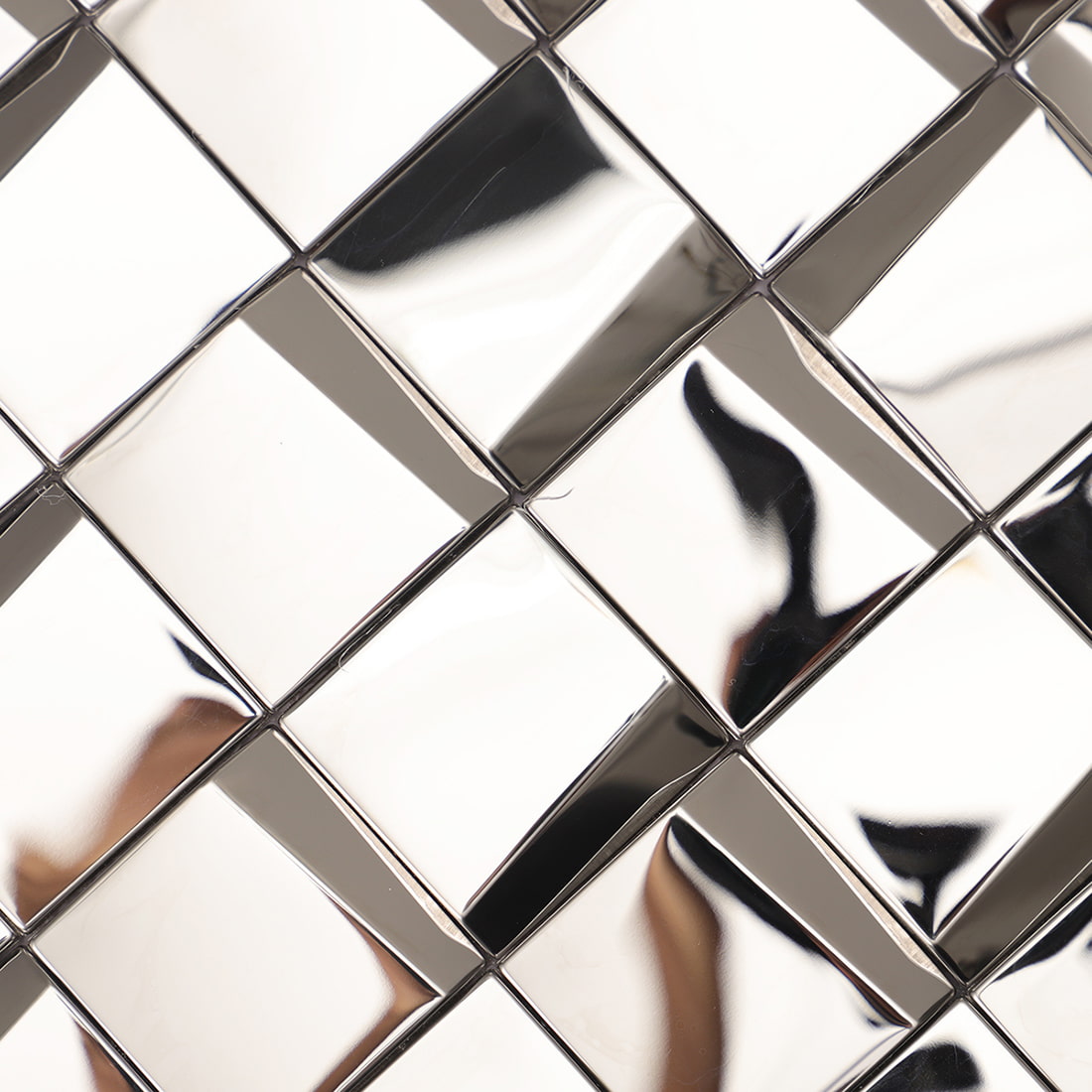Macro view of a polished silver 3D geometric mosaic tile surface with reflections.