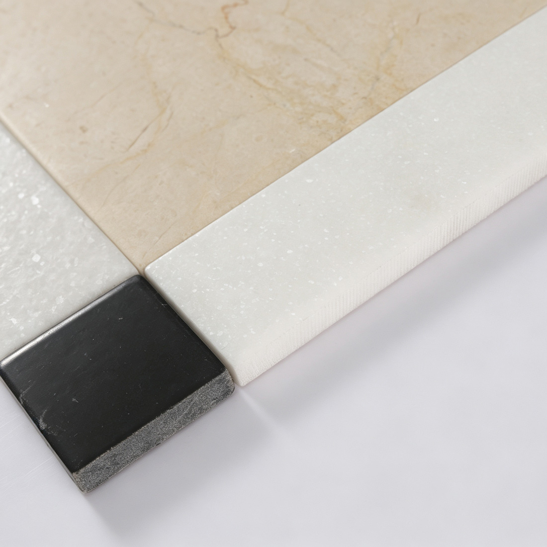 Close-up showing beige white and black marble border tile edge thickness