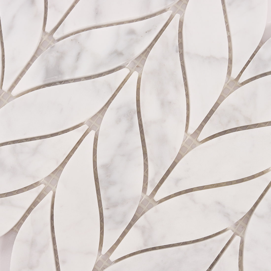 Top view close up of white marble leaf mosaic pattern on mesh backing