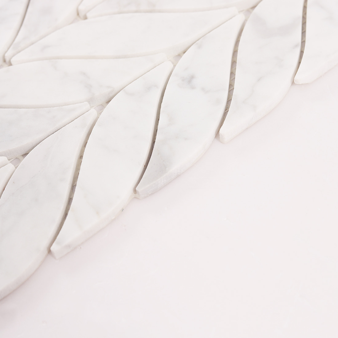 Angled close up of marble leaf mosaic tile thickness and smooth polished surface