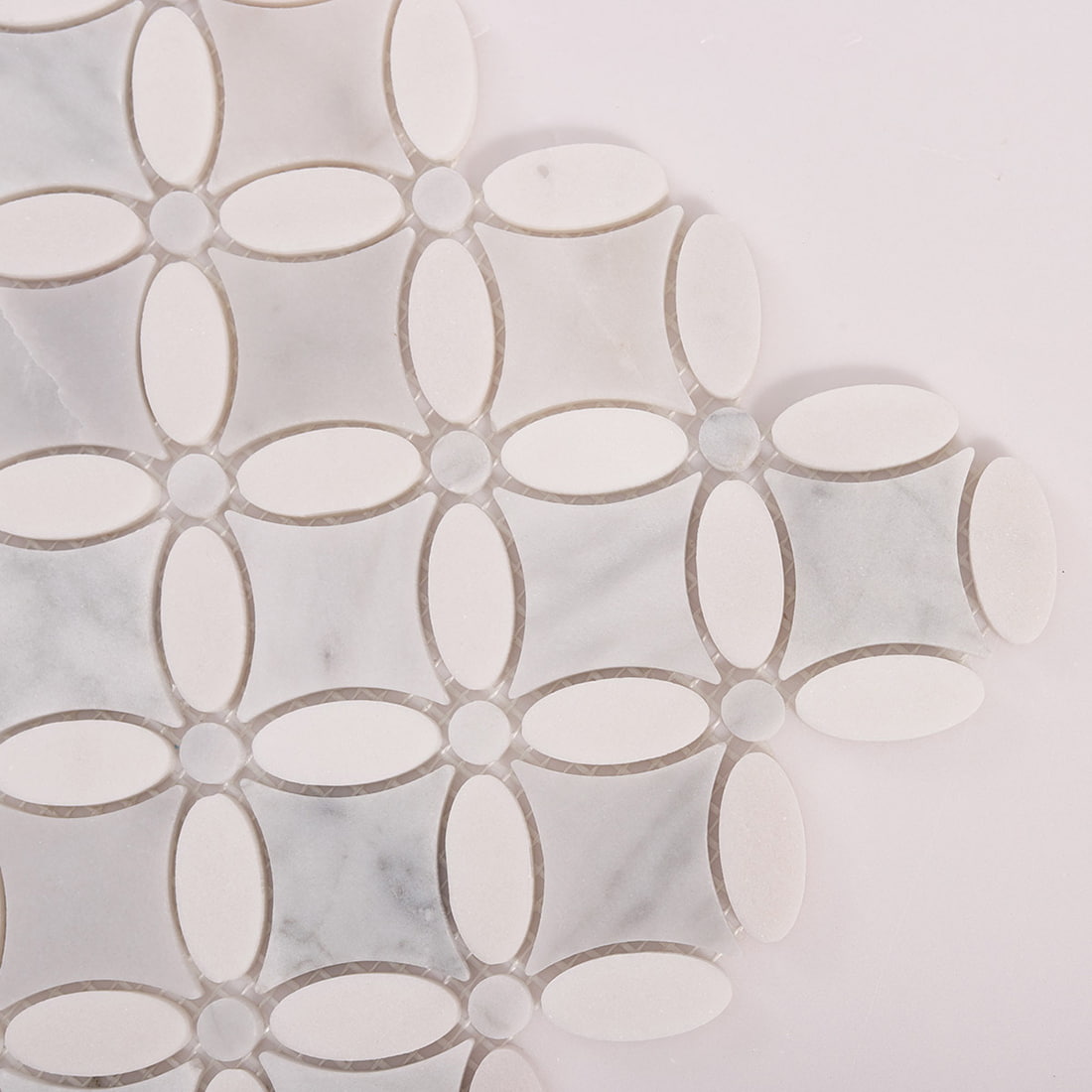 Corner detail of marble oval flower mosaic with oval petals and round dots