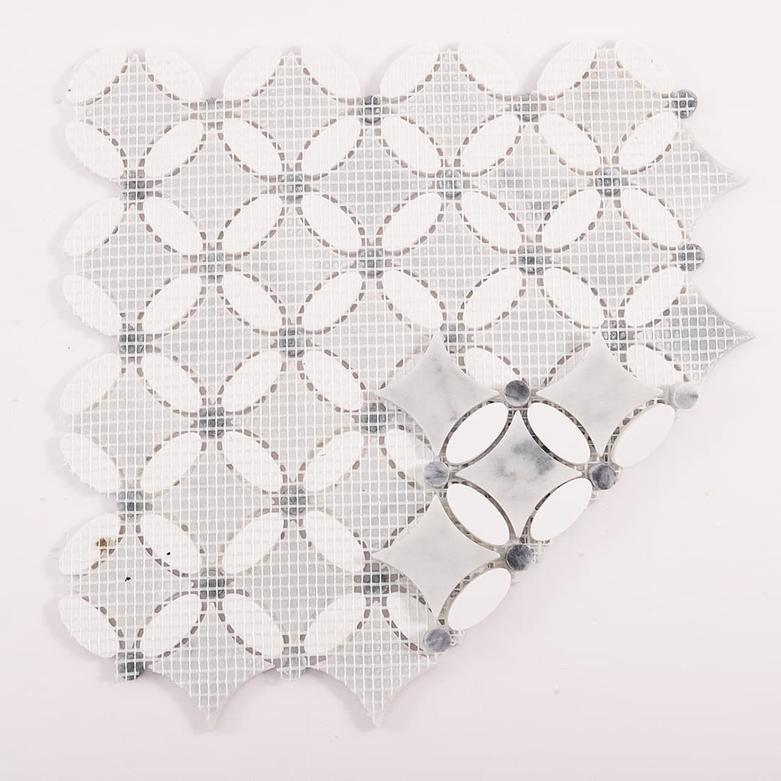 Back view of mosaic tile sheet with mesh backing and folded corner