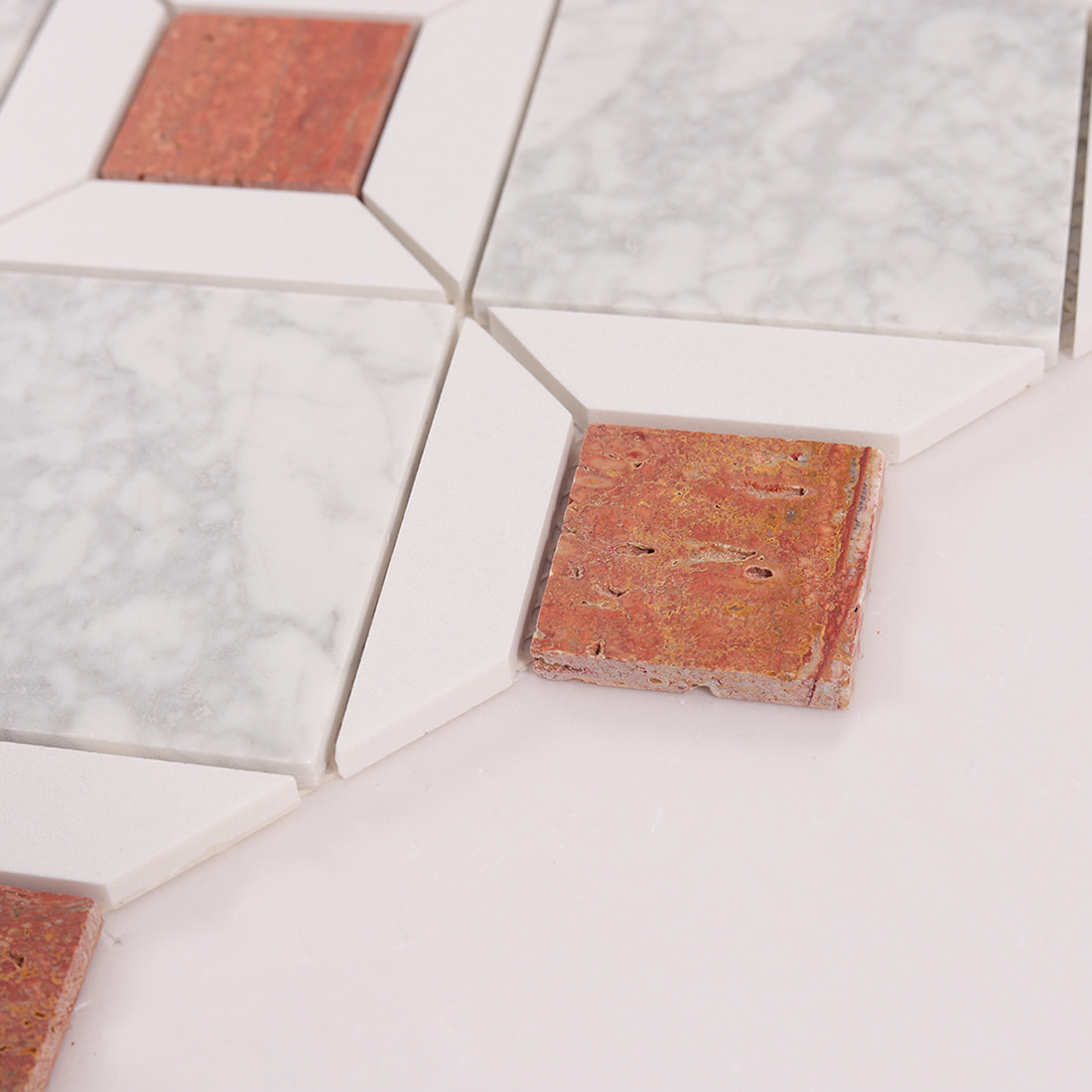 Angled view of marble mosaic tiles showing natural stone texture and thickness
