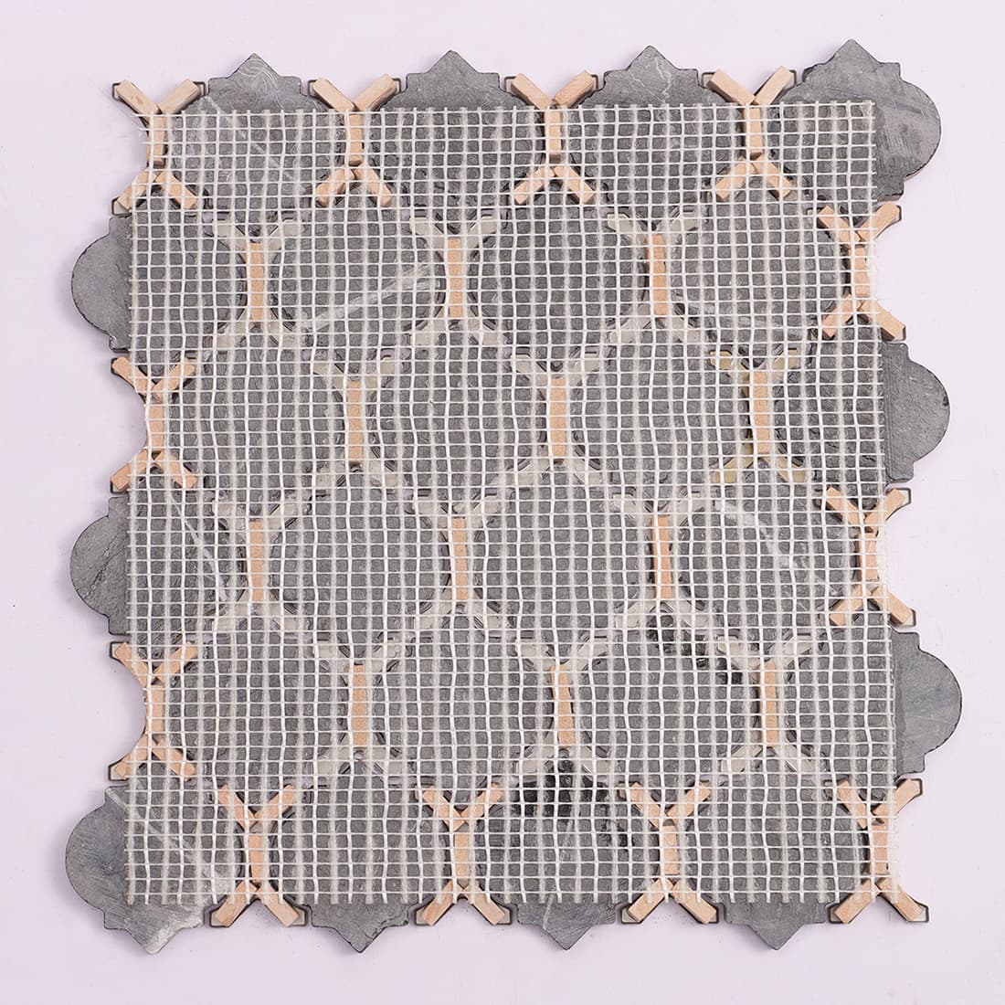 Mesh back view of black marble and gold metal mosaic tile sheet