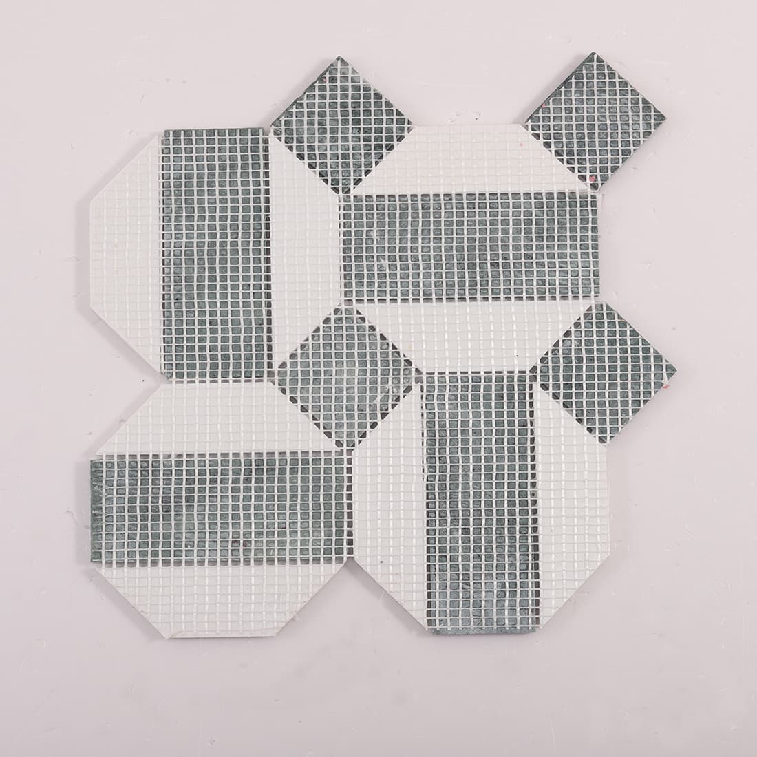 Back view of geometric marble mosaic sheet showing fiber mesh backing