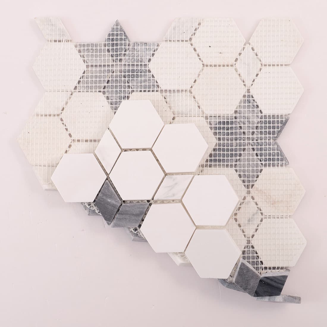 Back view of mesh-backed mosaic sheet with white hexagons and grey star inlays.
