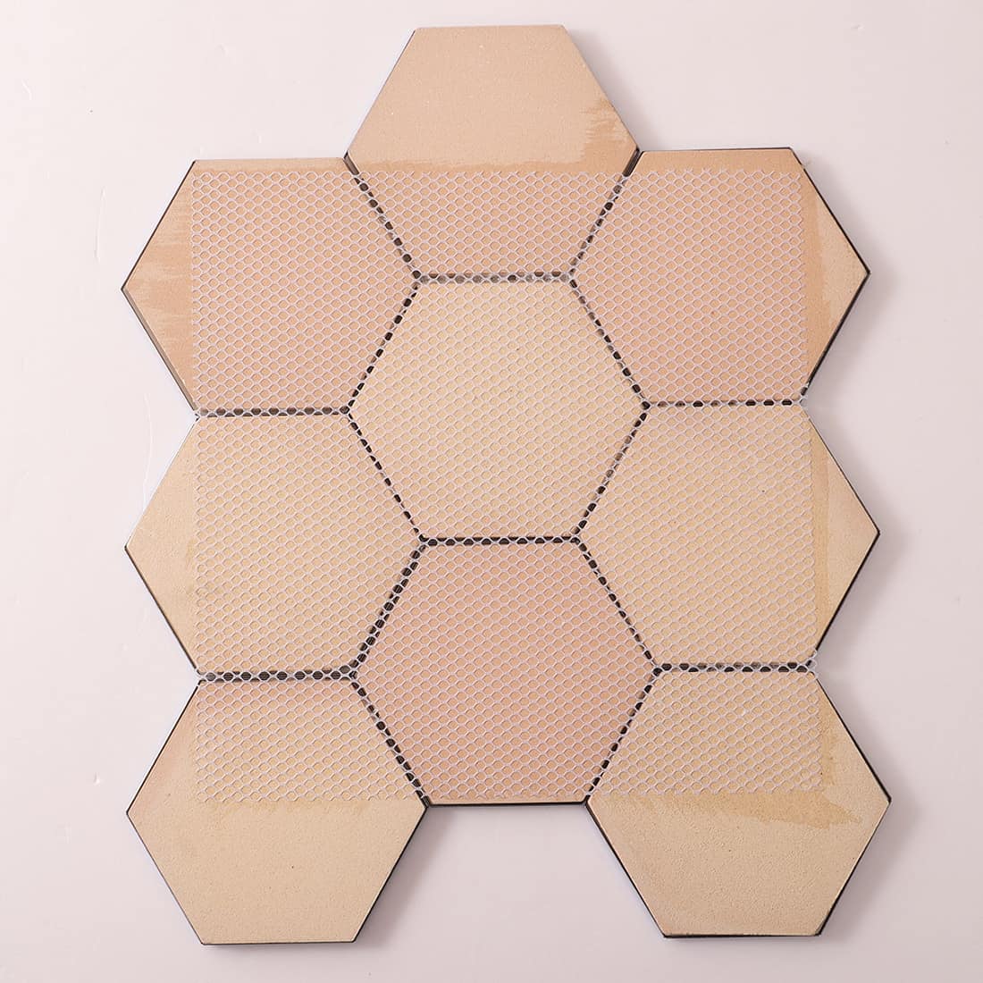 Rear view of blue 3D hexagon tiles showing white fiber mesh backing.