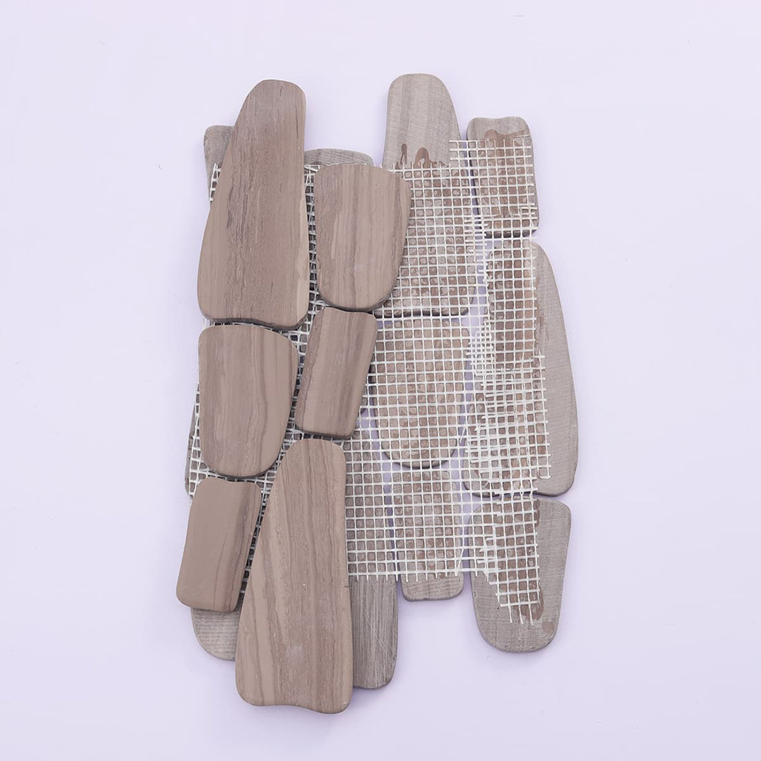 Back view of mesh-mounted taupe pebble stone mosaic tile sheet