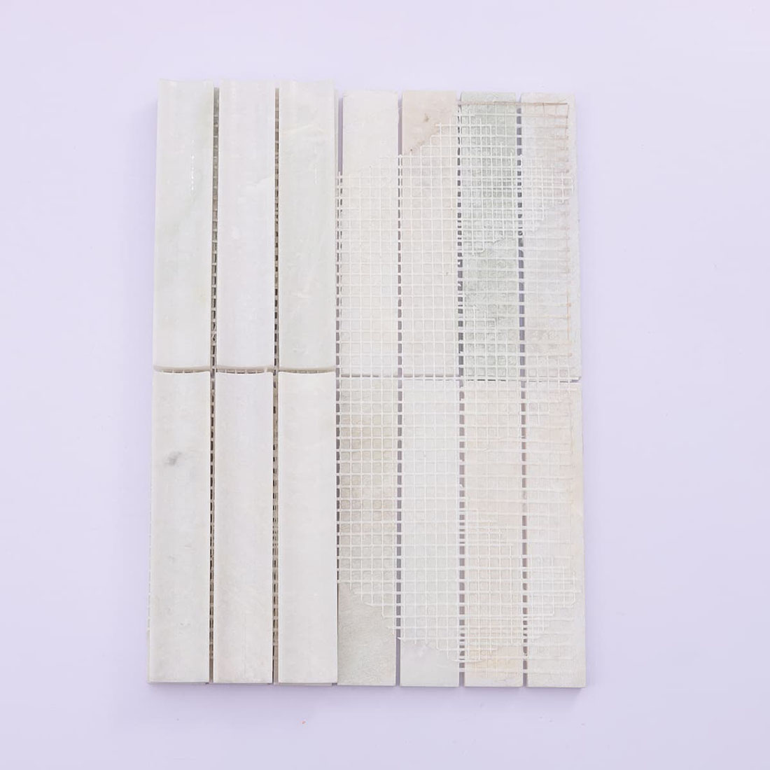 Back view of mesh-mounted white marble vertical strip mosaic tile sheet