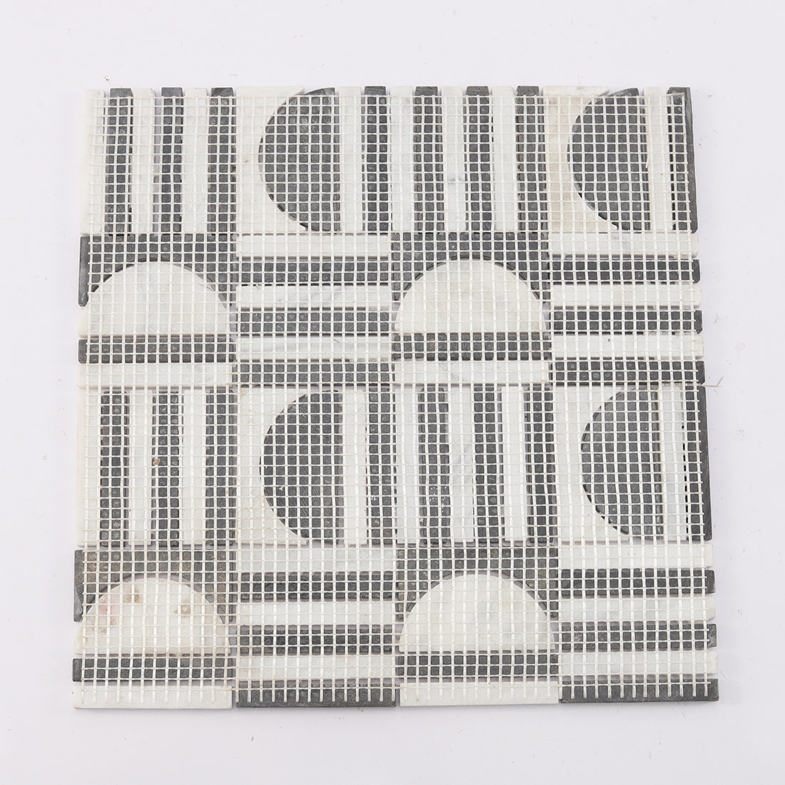 Back view showing the mesh netting of the marble mosaic tile.