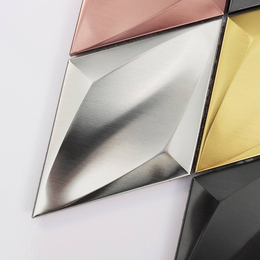 Corner detail of mixed color diamond metal mosaic tiles