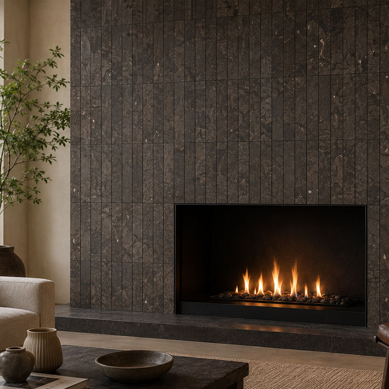 Modern fireplace tiles in dark stone covering a vertical gas fireplace surround