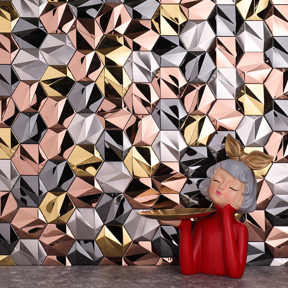 An expansive view of the faceted metal wall showing varied light reflections.