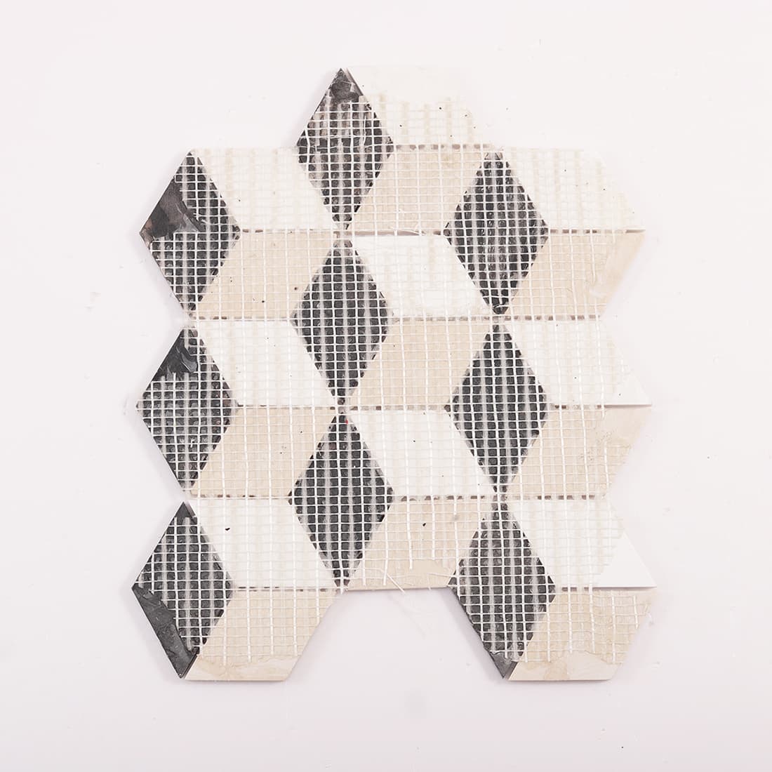 Back of mosaic tile sheet showing fiberglass mesh backing