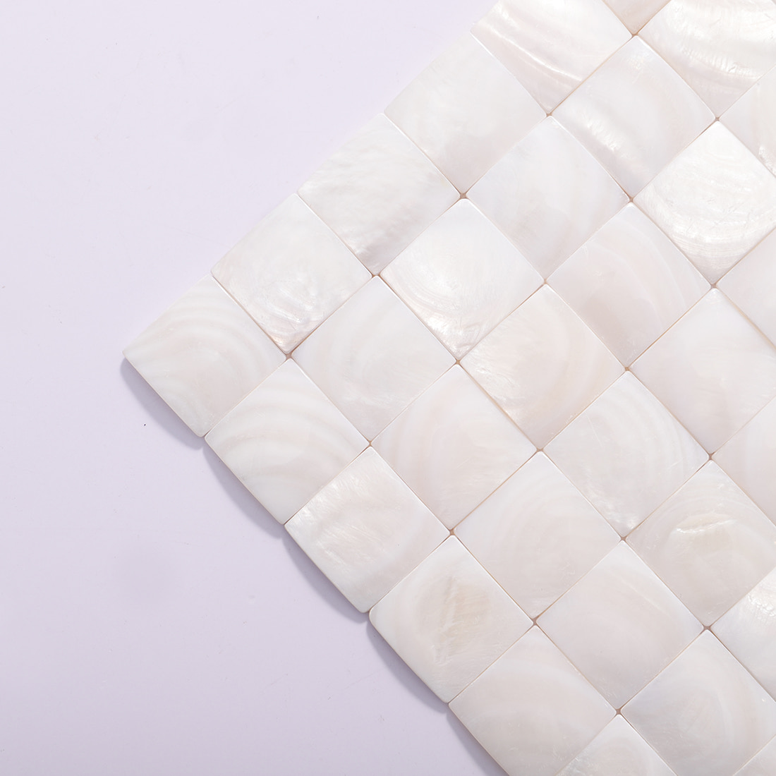 Close up of mosaic sheet corner showing glossy square tiles