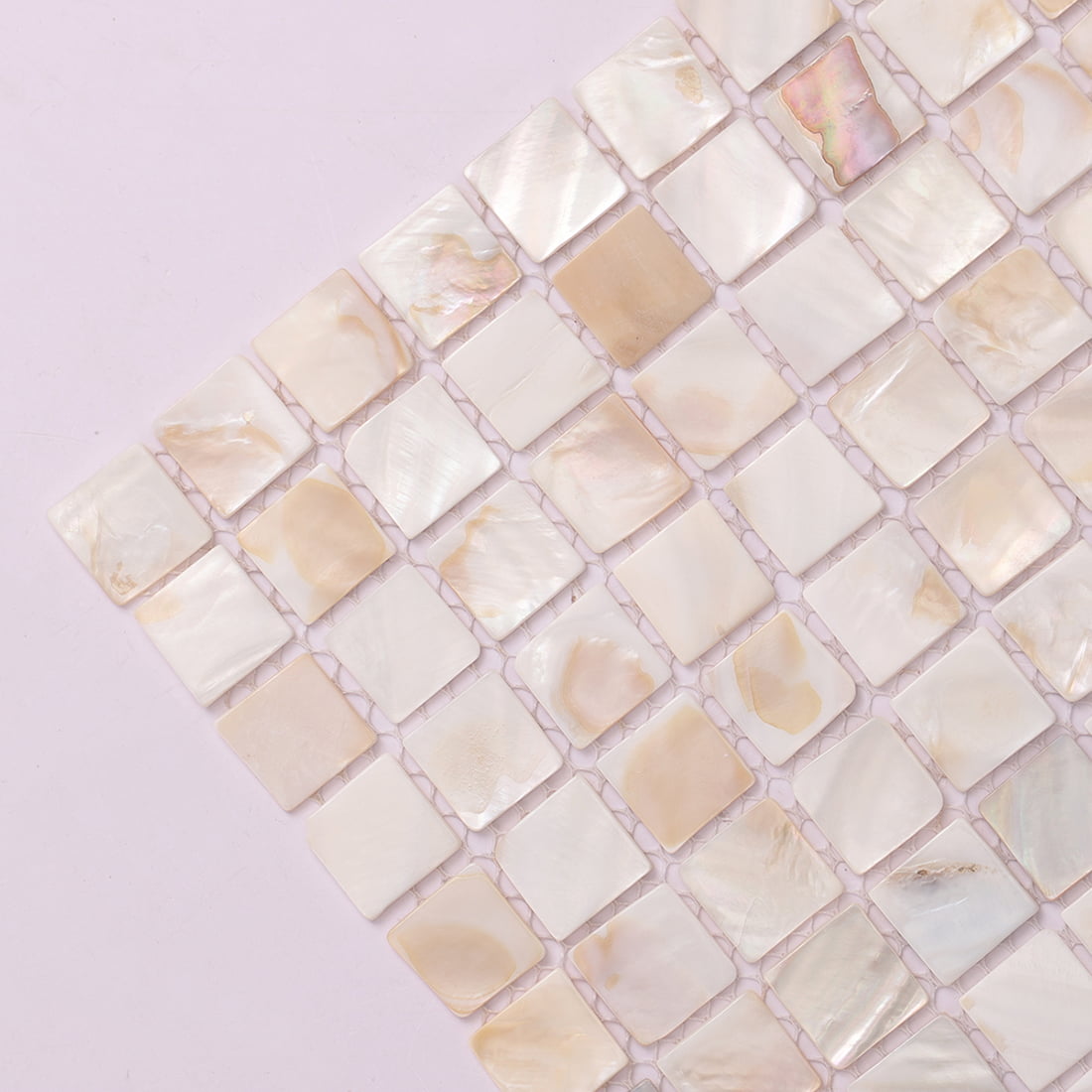Diagonal corner closeup of mother of pearl square mosaic tiles