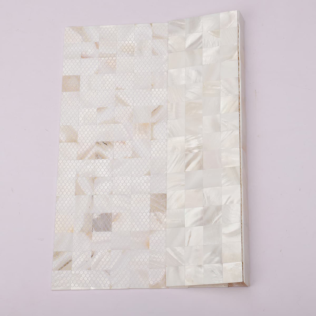 Side profile of mother of pearl mosaic tile sample board showing backing