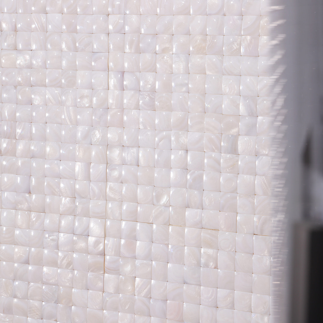 Close view of installed mosaic wall highlighting shine and reflections