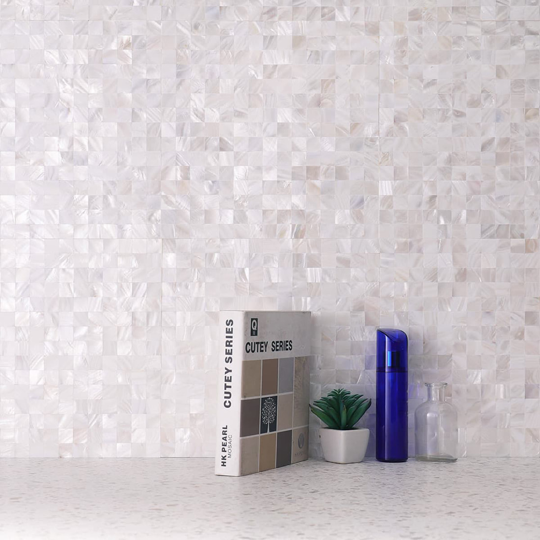 Installed mother of pearl mosaic wall with decor on countertop