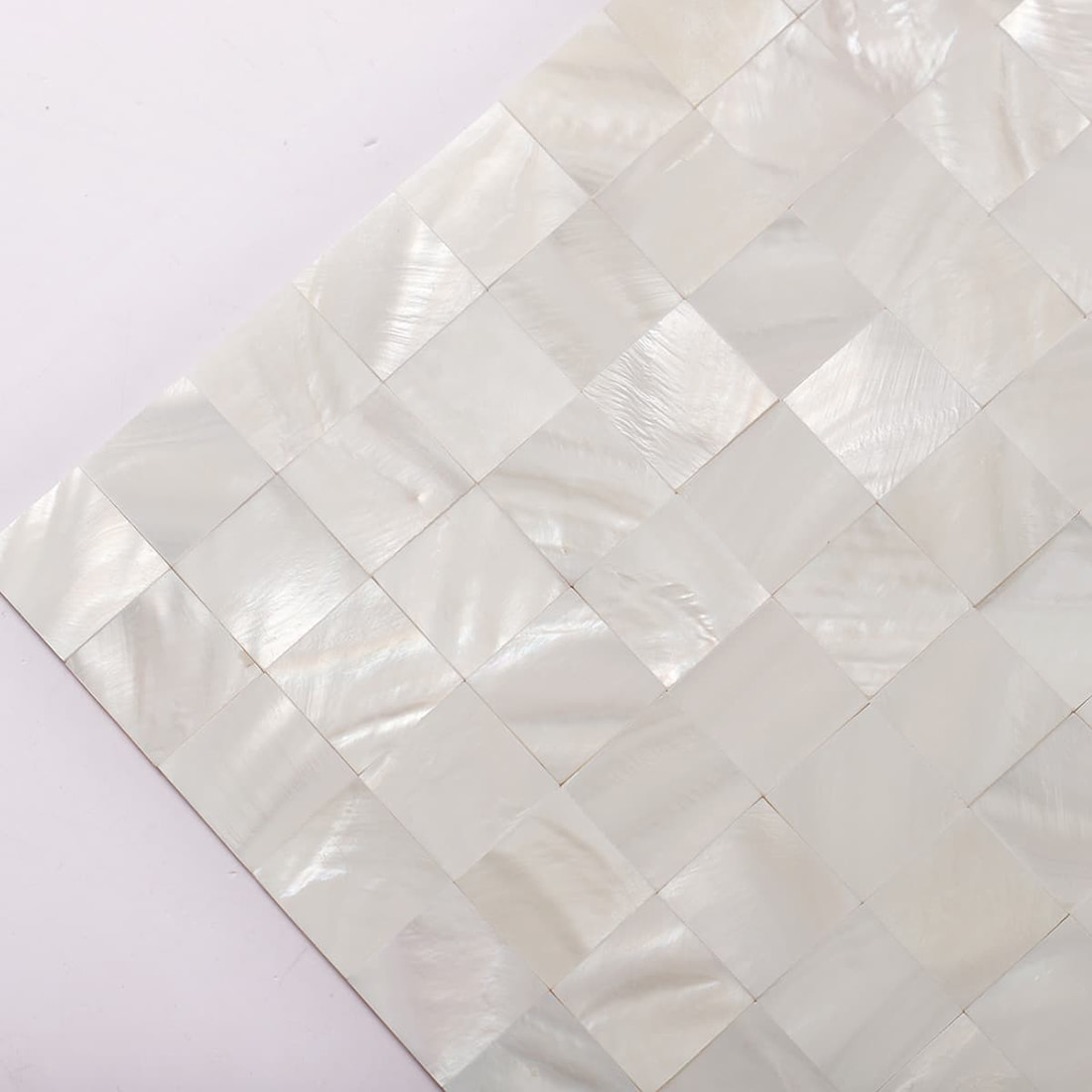 Close up of white mother of pearl square mosaic tile sheet