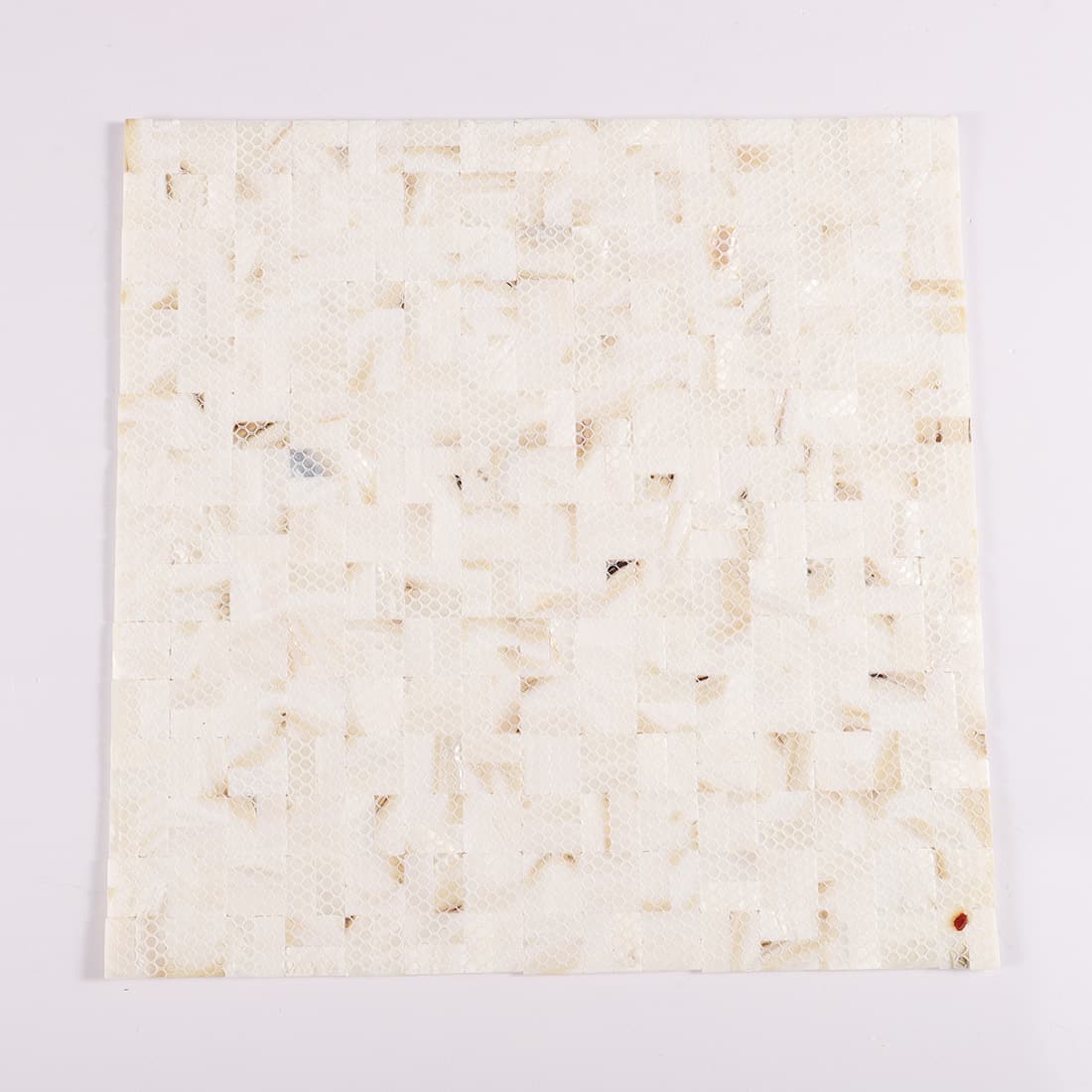 Back view of mother of pearl basketweave mosaic sheet with mesh backing