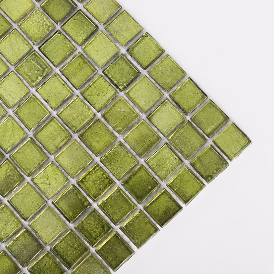 Diagonal corner view of olive green glass mosaic tiles with textured surface