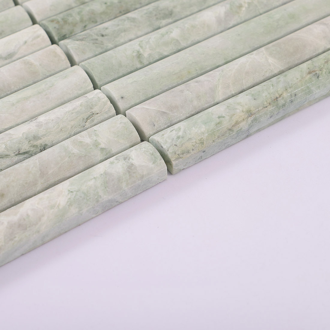 Pale green marble half round tile showing thickness and a raised curved profile