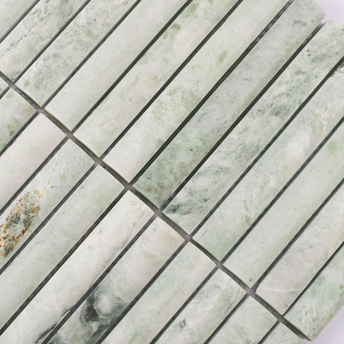 Pale green marble linear mosaic showing spaced joints and varied stone patterns