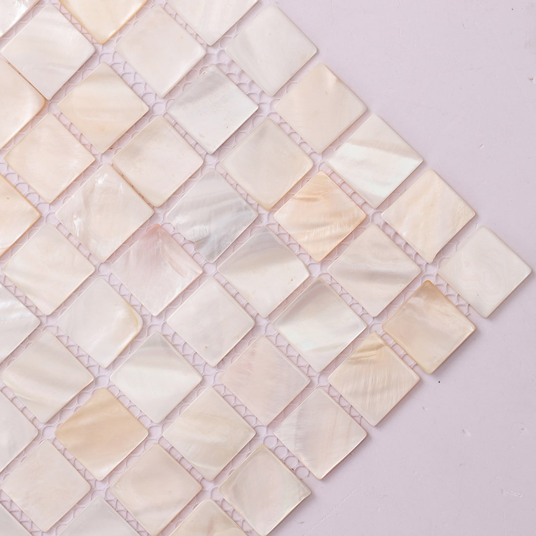 Corner view of pearl shell square mosaic tile on mesh backing