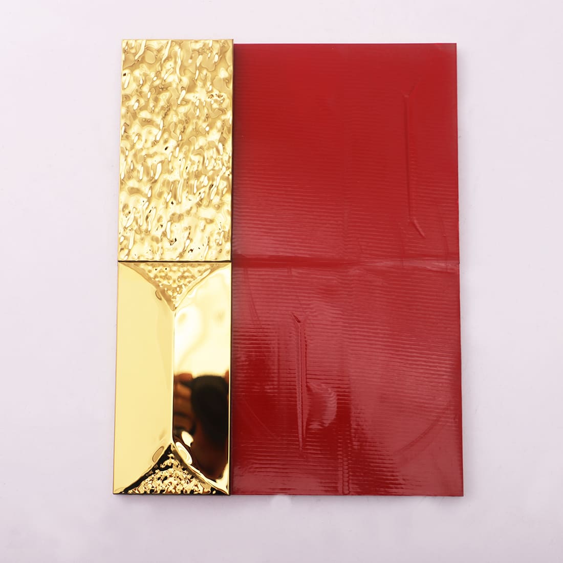 Side-by-side view of a textured gold panel and a red textured panel on a white surface.