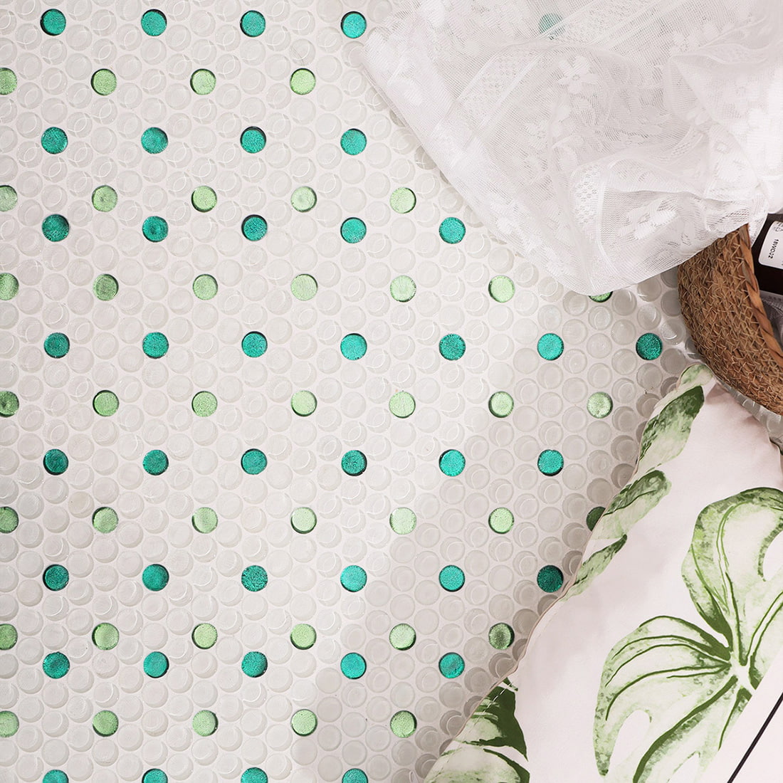 Styled floor scene with penny round glass mosaic tile and green foil dots