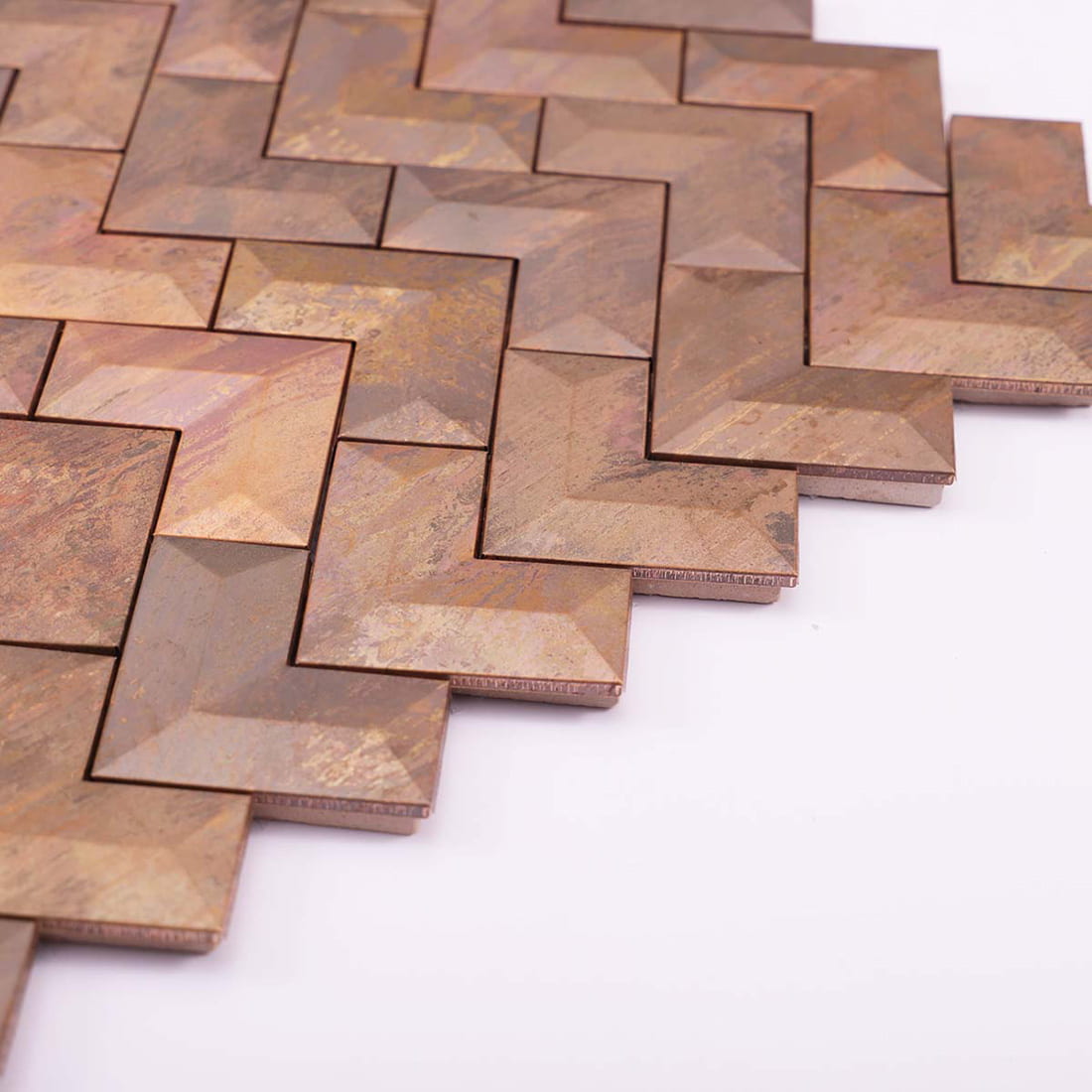 Perspective view showing the 3D beveled texture of antiqued copper chevron tiles.