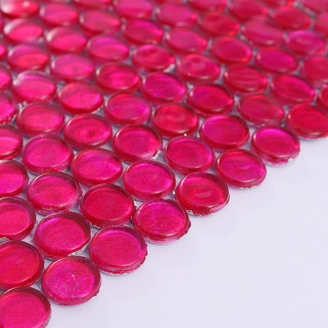 Detailed close up of pink foil penny round glass mosaic tiles with smooth edges