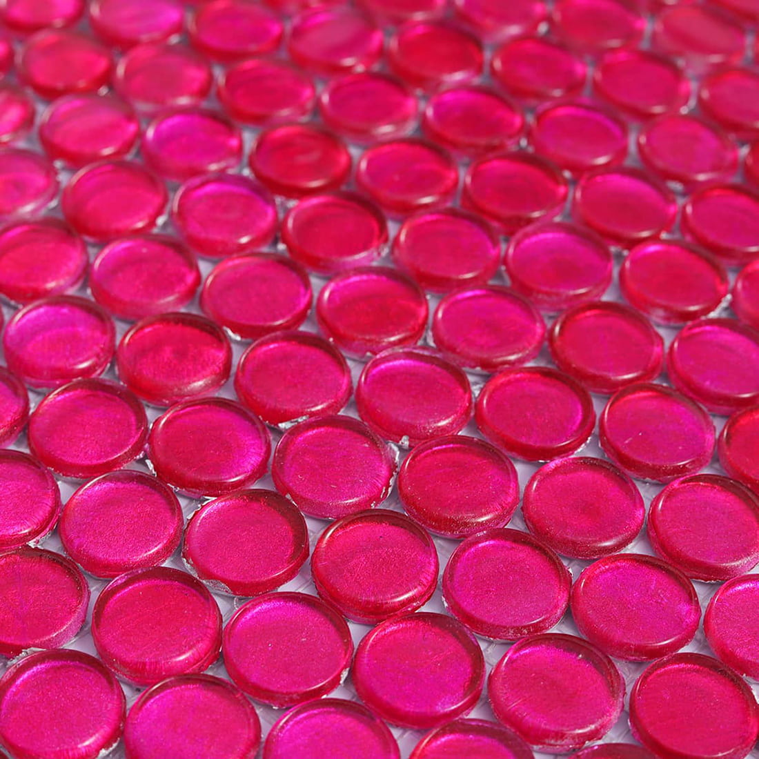 Close up of pink foil round glass mosaic tile highlighting glossy surface texture