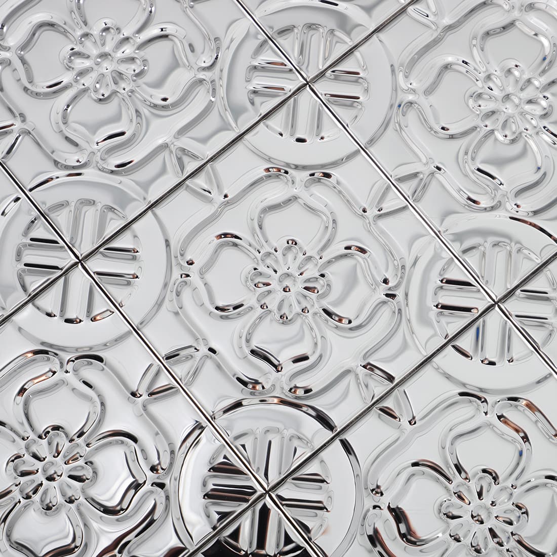Polished silver embossed flower mosaic tile surface detail