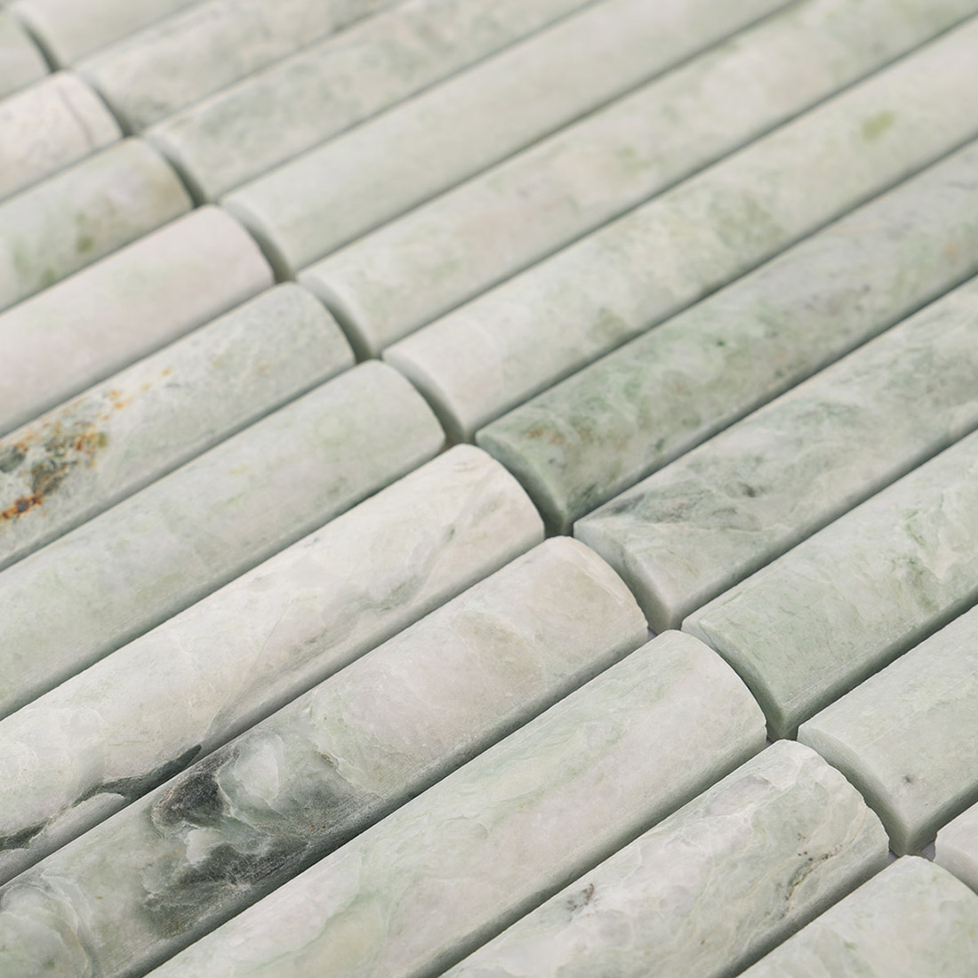 Raised half round pale green marble strips with smooth curved surfaces