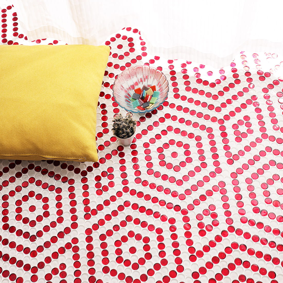 Geometric decorative design created with red penny round glass mosaic tiles